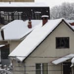 snow covered roofs of houses on a winter day, after a snowfall.