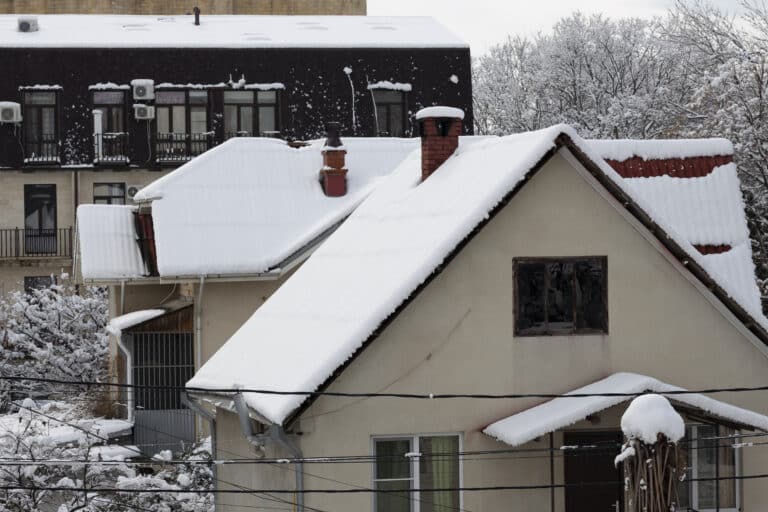 snow covered roofs of houses on a winter day, after a snowfall.